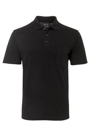 The JBs Pocket Polo is a regular-fit, plain black short sleeve polo with a collar, three-button placket, and left chest pocket. Made from soft polyester cotton and shown on a white background.