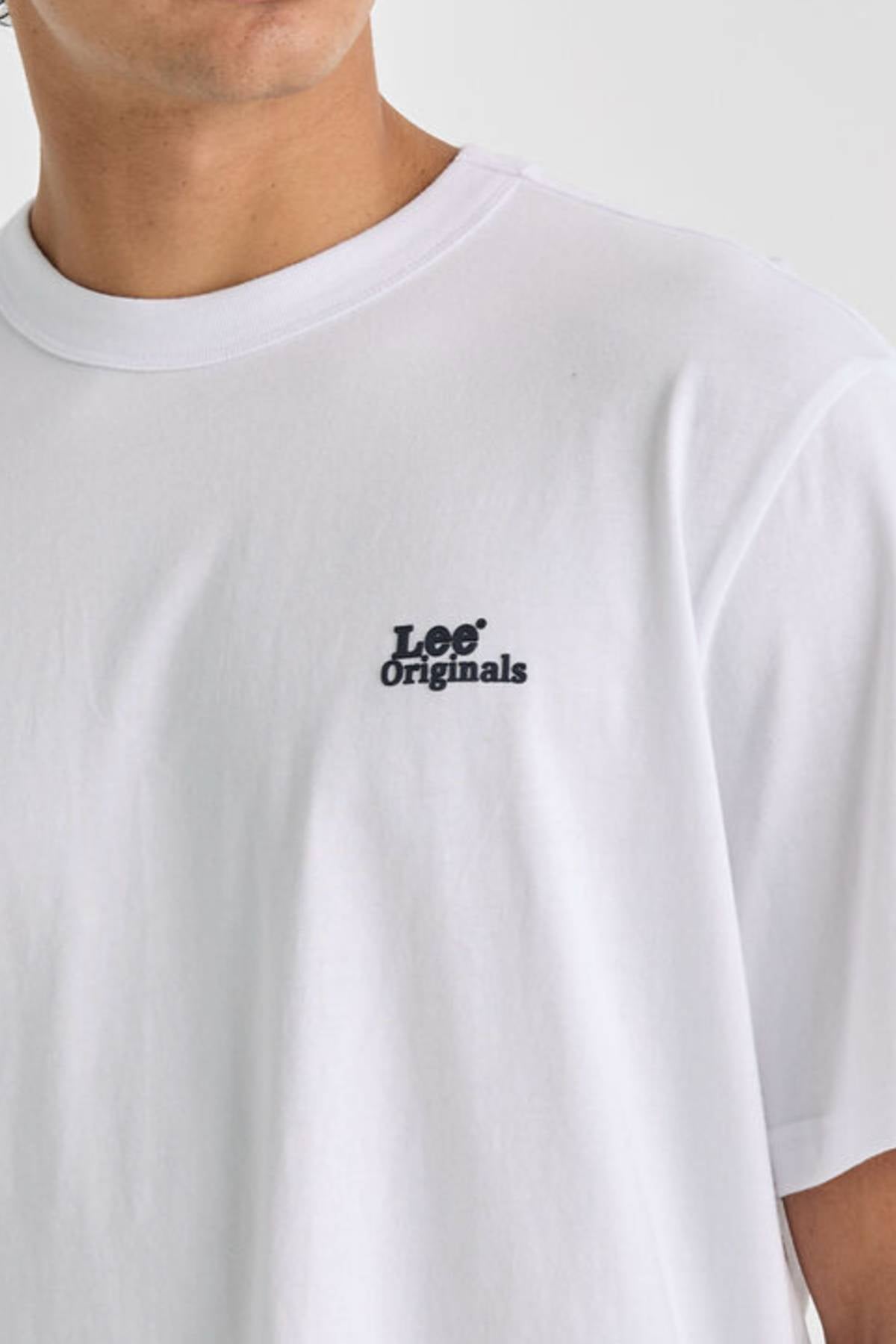 Someone wearing the Lee Originals Relaxed Tee, crafted from 100% cotton and featuring a black "Lee Originals" logo on the left chest. Only their upper body is visible against a neutral background.