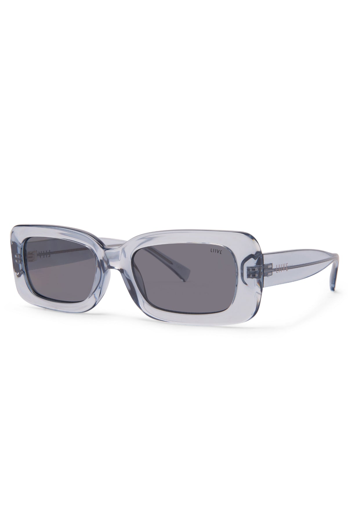 Liive Crush Sunglasses feature a rectangular shape, translucent pale blue frames, and dark gray lenses for stylish UV protection. Shown angled on white, these vintage 90s shades add a cool retro vibe to any outfit.
