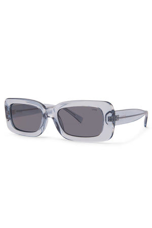 Liive Crush Sunglasses feature a rectangular shape, translucent pale blue frames, and dark gray lenses for stylish UV protection. Shown angled on white, these vintage 90s shades add a cool retro vibe to any outfit.
