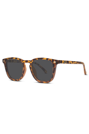 The Liive Manhattan Polar Sunglasses feature a tortoiseshell pattern, dark polarized lenses, thick square frames, and gently curved arms for stylish UV protection, shown on a white background.