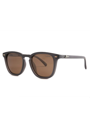 Introducing the Liive Manhattan Polar Sunglasses: a stylish pair with a dark brown matte finish and rectangular lenses. These classic frames, crafted from durable polycarbonate, feature a subtle brand name on the temples. Equipped with tinted lenses for UV protection, these sunglasses are presented against a plain white background.
