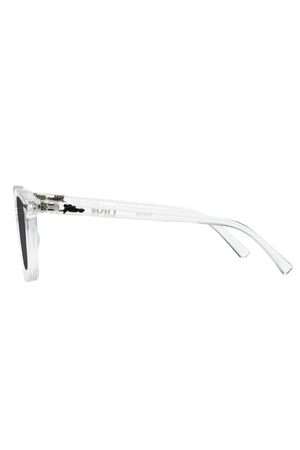 The Liive Manhattan Polar Sunglasses feature a pair of transparent, rectangular lenses with dark, polarized filters, viewed from the side. The lightweight polycarbonate frame and temple arms are clear, showcasing a minimalist and modern design that ensures UV protection.