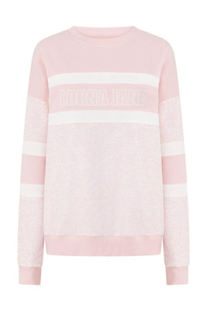 The Lorna Jane Dreamer Oversized Sweat in light pink features white stripes, "LORNA JANE" text across the chest, a crew neckline, ribbed cuffs and hem, and is made from a soft cotton blend terry for all-day comfort.