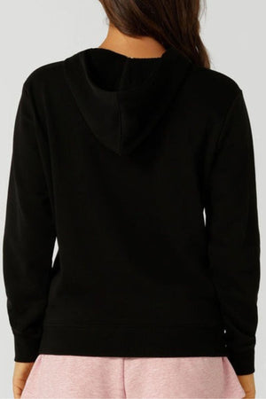 A person with long brown hair is shown from the back wearing a black Lorna Jane Lotus Hoodie, made of a breathable cotton blend, and a light pink piece against a plain grey background.