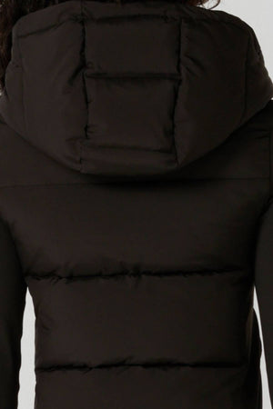 A close-up of the back of a person wearing the Lorna Jane Warm Up Thermal Combo Puffer in black, featuring an adjustable hood, horizontal stitching, and thick insulated material.