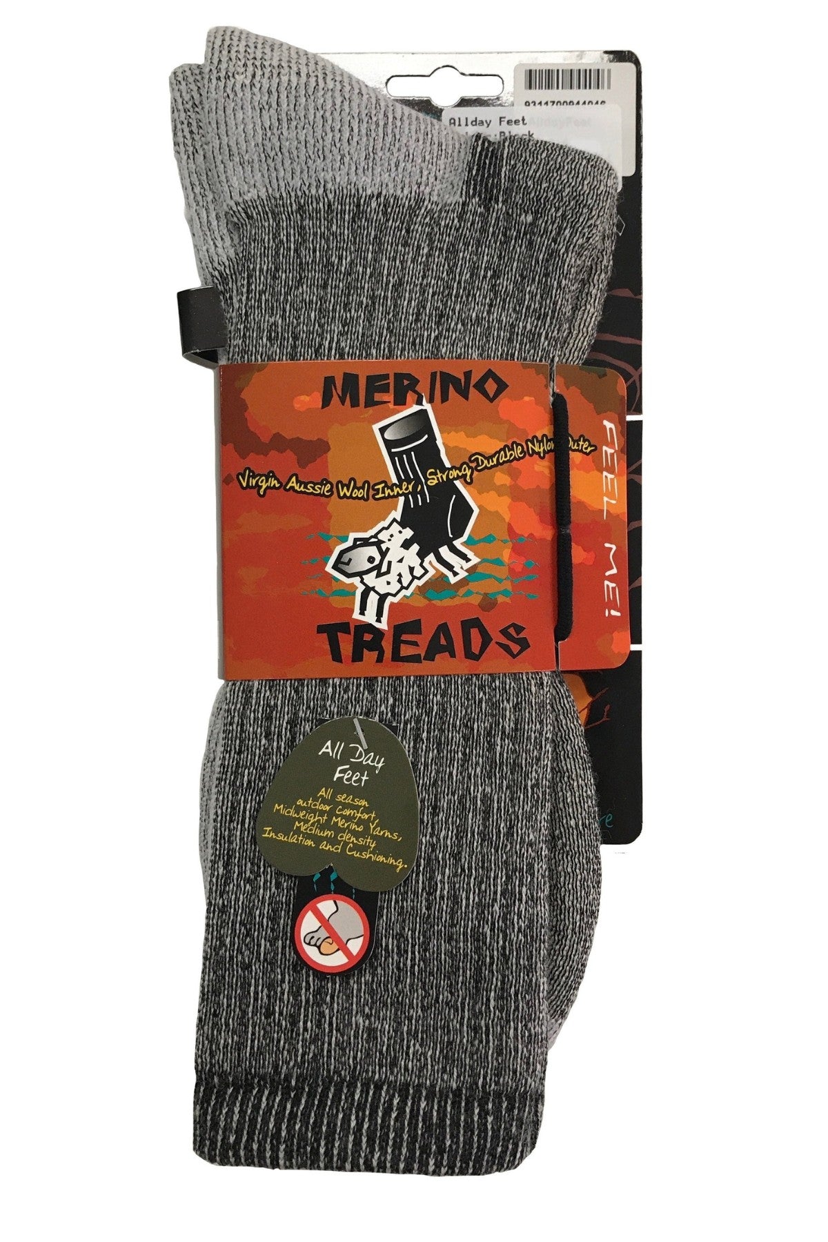 A pack of Merino Treads Allday Feet socks features a cartoon sheep and no-smoking icon. Made in Australia, these grey socks have black and white marled patterns. The package says "Feel Me!" and highlights Australian wool.