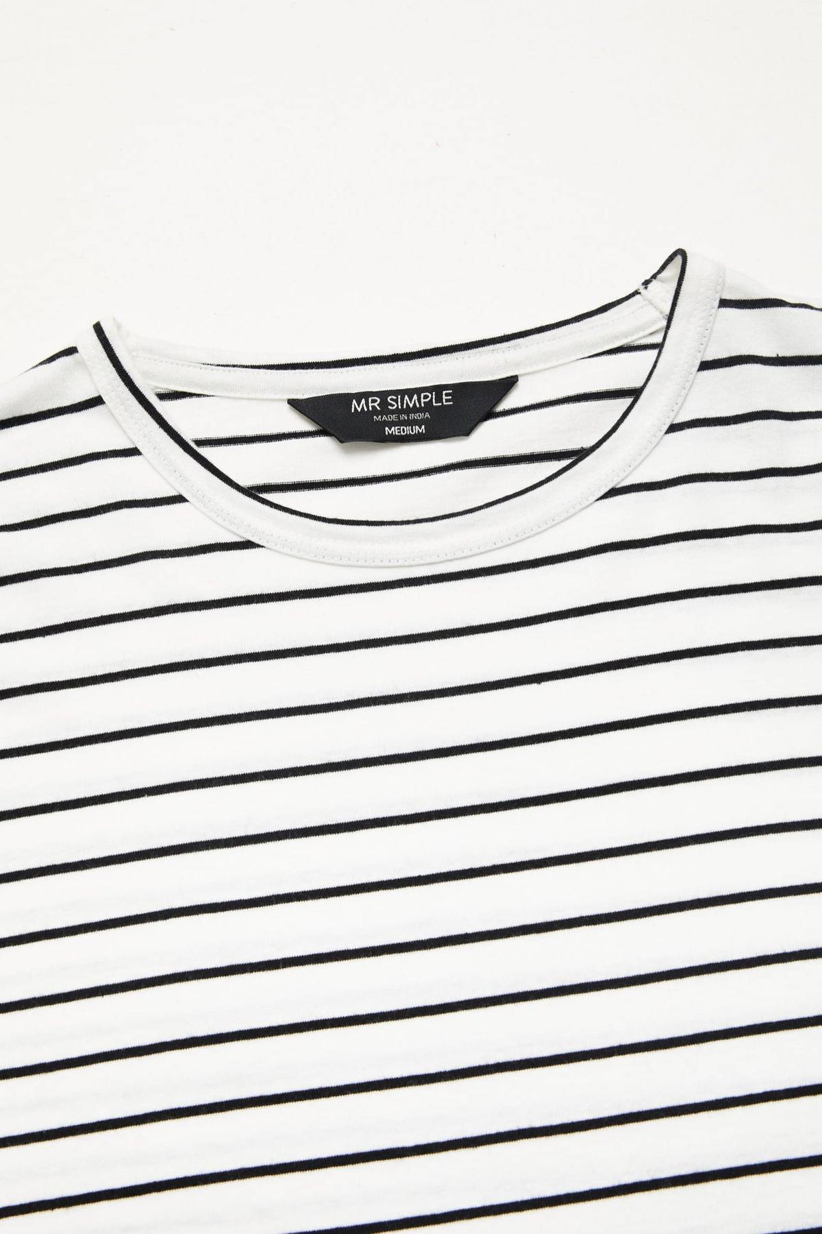 A close-up of the Mr Simple Breton Stripe Tee showcases its white crewneck design adorned with thin black horizontal stripes. Inside the collar, the label displays "MR SIMPLE" with the size marked as "MEDIUM." Made entirely from 100% organic cotton, this tee features a white neckline and fabric that looks soft and lightweight.