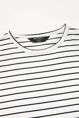 A close-up of the Mr Simple Breton Stripe Tee showcases its white crewneck design adorned with thin black horizontal stripes. Inside the collar, the label displays "MR SIMPLE" with the size marked as "MEDIUM." Made entirely from 100% organic cotton, this tee features a white neckline and fabric that looks soft and lightweight.