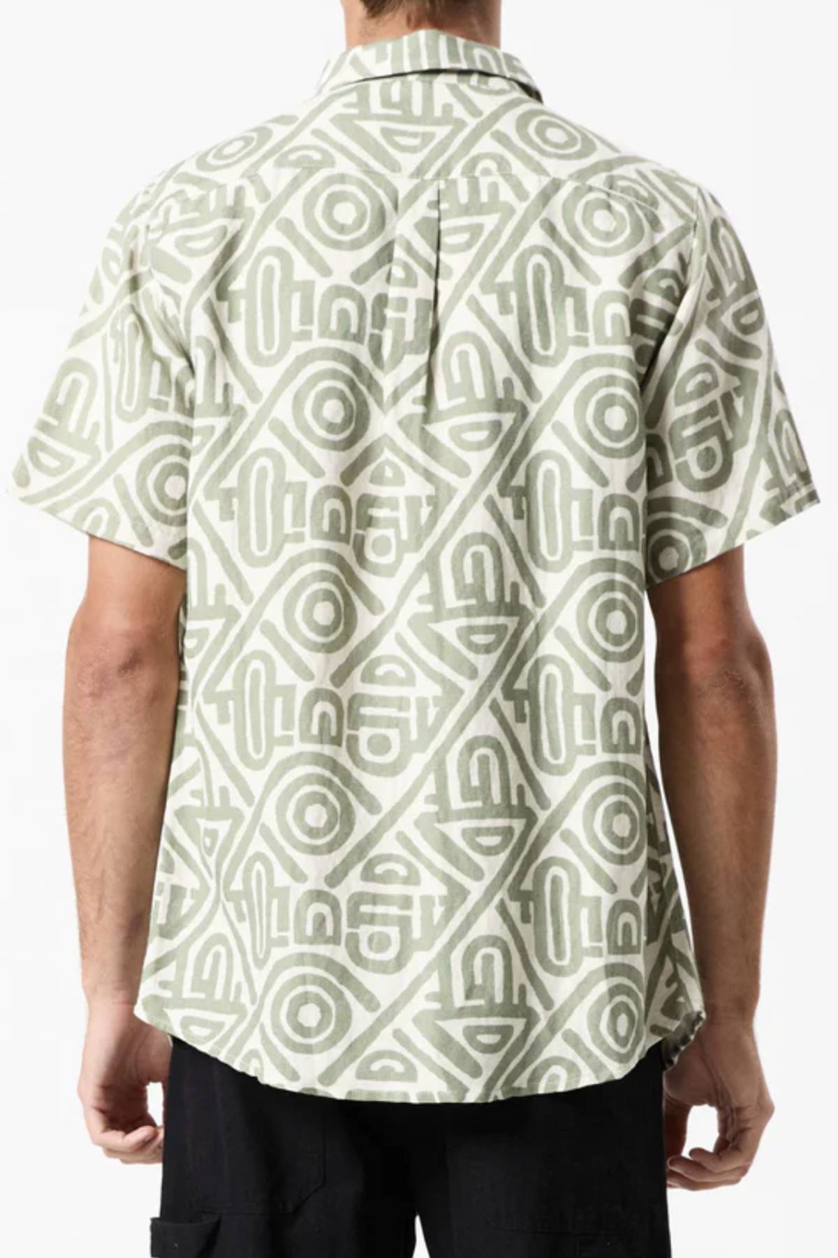 A person is seen from behind wearing a Mr Simple Earl Short Sleeve Shirt in light green and white geometric pattern. The collared, loose-fit shirt exudes a casual vibe when paired with dark pants, creating a stylishly relaxed ensemble.
