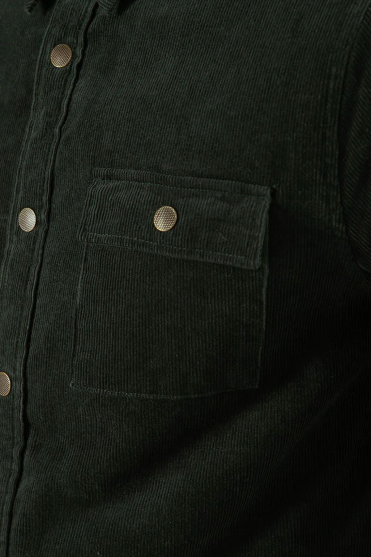Close-up of the Mr Simple Quilted Cord Jacket in dark green cotton corduroy, highlighting a chest pocket with flap and metal snap closure, plus part of the front placket with matching snap buttons.