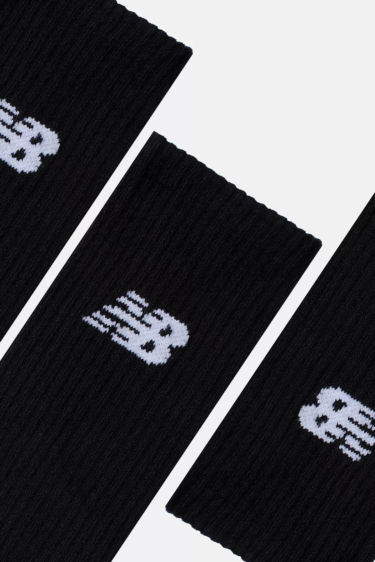 Three black New Balance Everyday Crew Socks, sold as a 3-pack, are arranged diagonally on a white background, each displaying a white "NB" logo near the top and featuring a cushioned footbed for comfort.