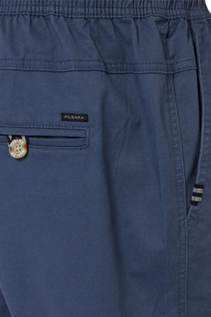 Close-up of Pilbara Cotton Stretch Short in blue with elastic waist, comfy fit, small buttoned pocket with "PILBARA" label, and a side seam pocket with striped trim—perfect cotton stretch shorts for daily wear.
