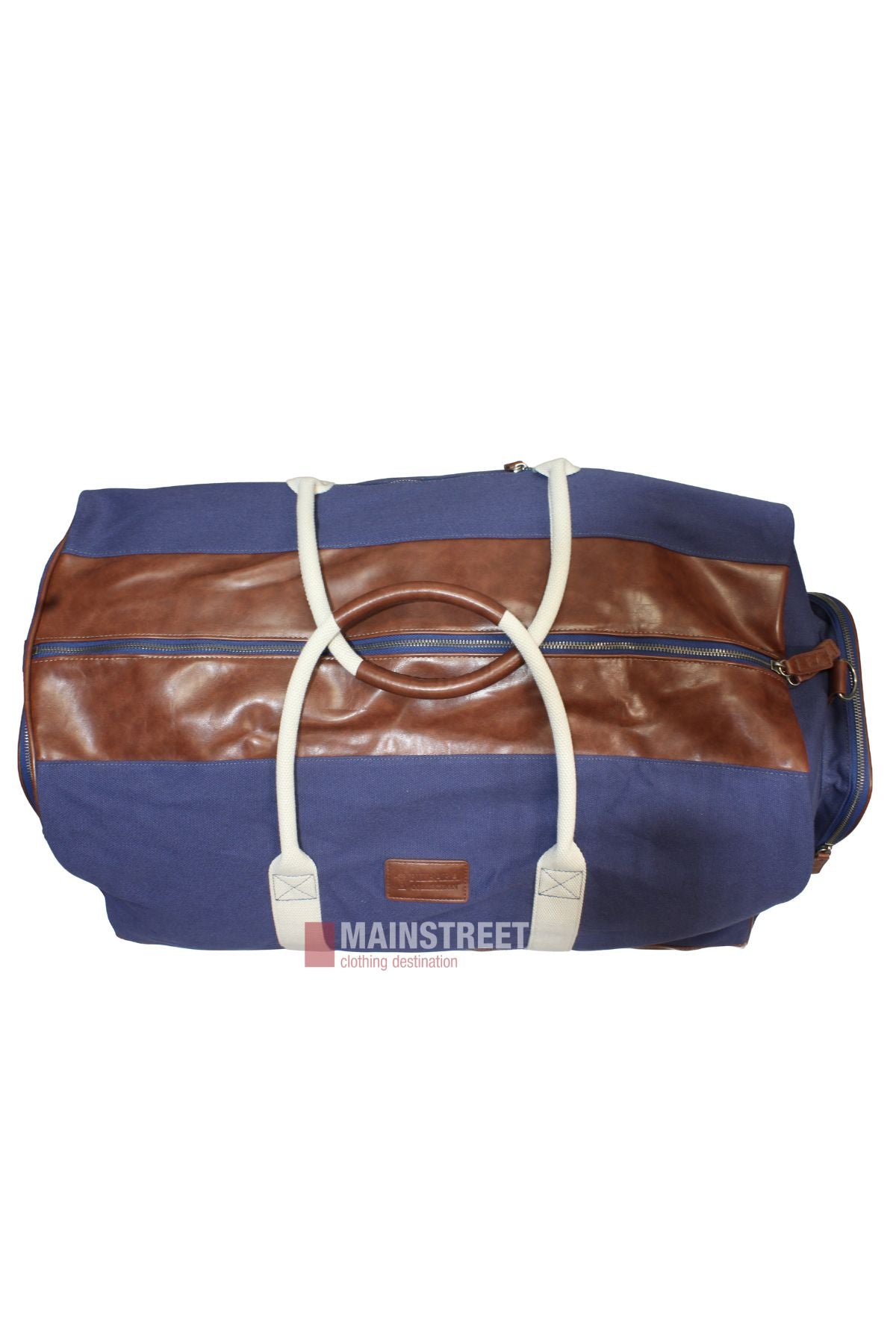 The Pilbara Long Weekender Bag features blue canvas, brown leather accents, white handles, a horizontal brown stripe with top zipper, and a "MAINSTREET" logo tag. Ideal for stylish travel.