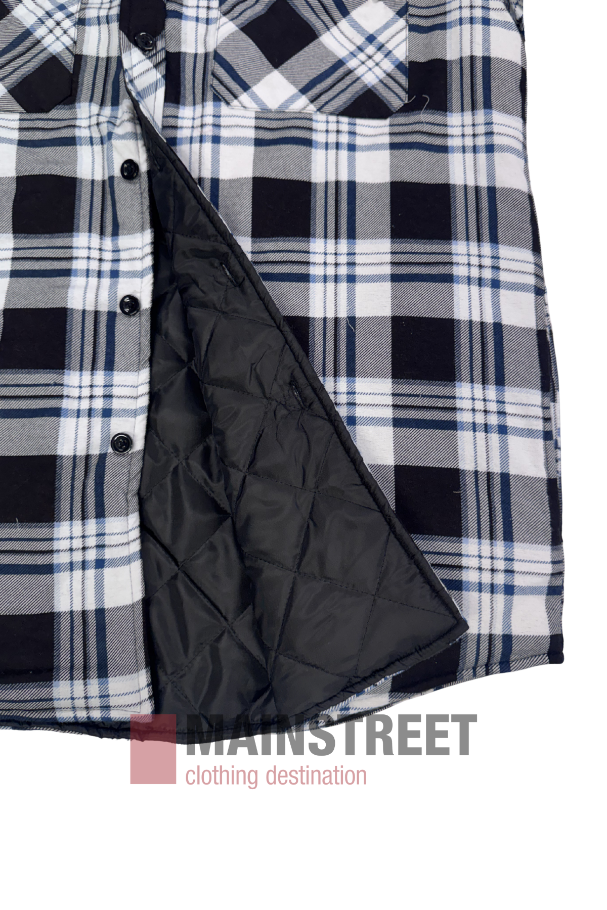 A close-up of the Pilbara Flannelette Quilted Shirt—black, white, and blue plaid cotton with black buttons, partially open to reveal its quilted black inner lining. The MAINSTREET clothing destination logo appears at the bottom.