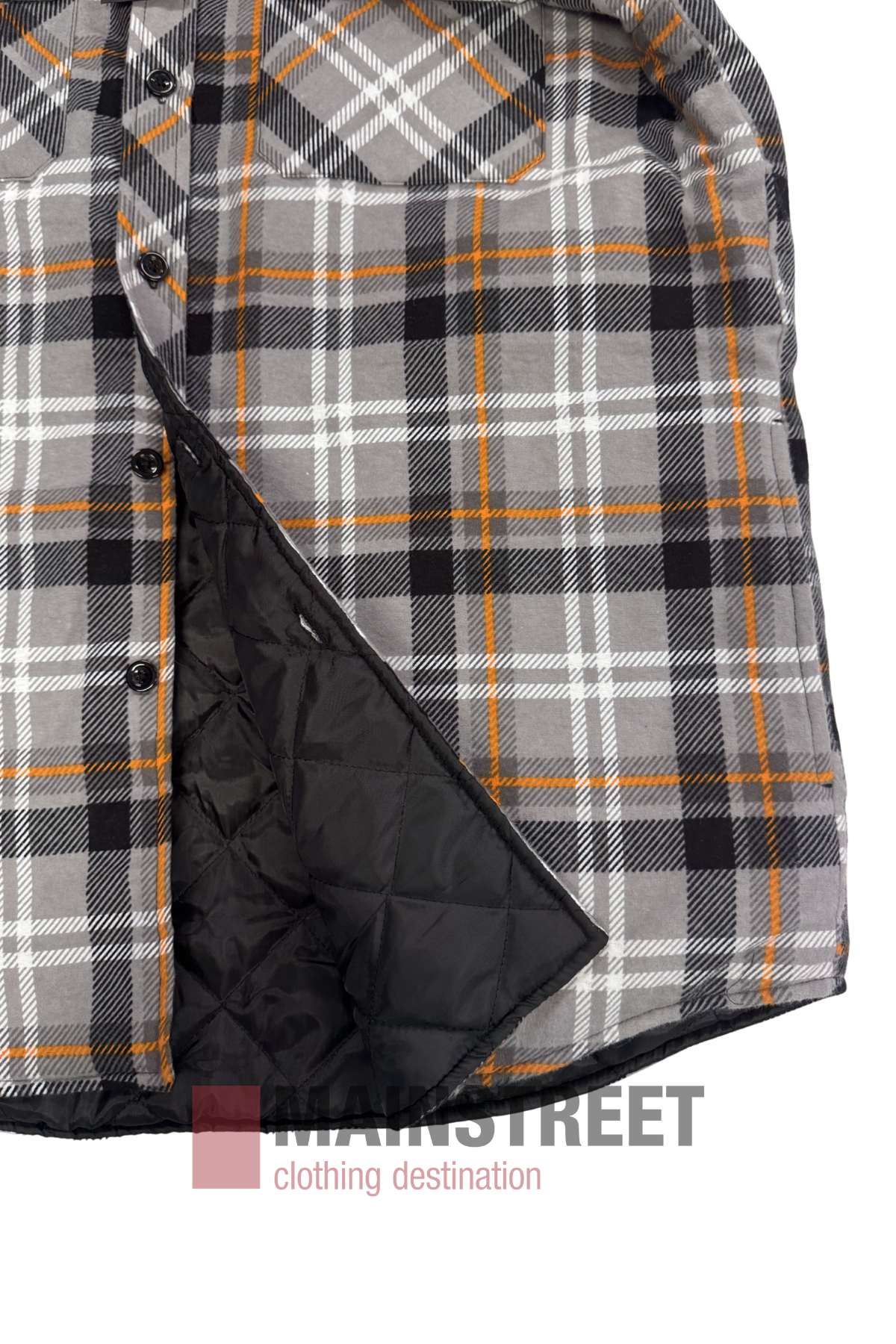 A close-up of the Pilbara Flannelette Quilted Shirt in gray, black, and orange plaid with black quilted lining, shown partially unbuttoned to reveal the inside. The "MAINSTREET clothing destination" logo appears below the jacket.