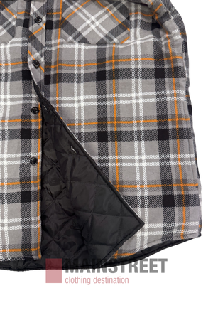 A close-up of the Pilbara Flannelette Quilted Shirt in gray, black, and orange plaid with black quilted lining, shown partially unbuttoned to reveal the inside. The "MAINSTREET clothing destination" logo appears below the jacket.