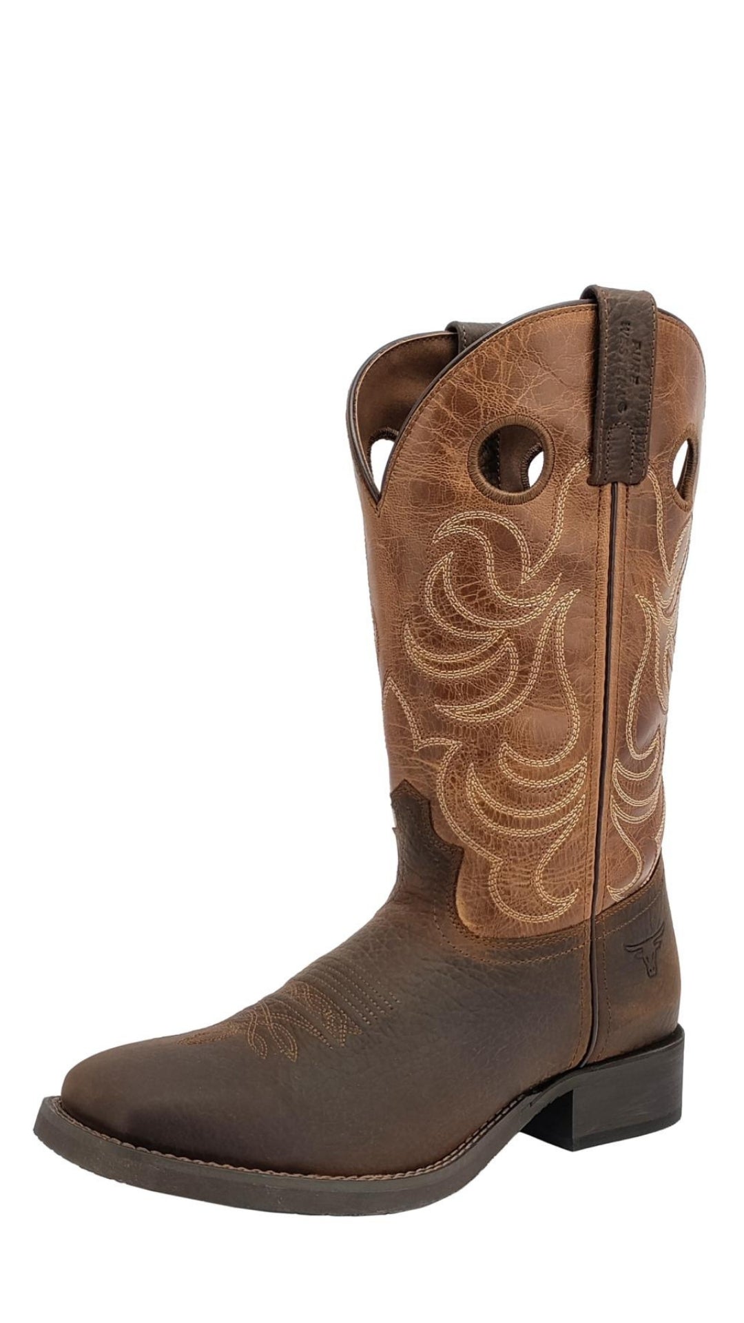 The Pure Western Denton Boot is a brown grained leather western boot with decorative stitching, pull tabs, two circular holes for easy wear, a short square heel, rounded toe, and a comfy memory foam insole.