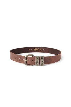 The RM Williams Drover Belt is made from rich vegetable-tanned leather with an antique brass buckle and two intricately designed metallic rings. It is circularly coiled and features several adjustment holes for a perfect fit.