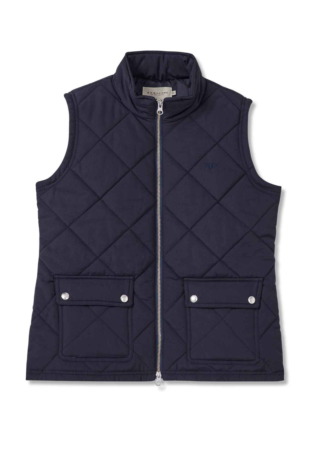 The RM Williams Willippa Vest is a navy blue sustainable vest featuring a quilted design, stand collar, front zipper, two large button-flap pockets, and stylish diamond stitching.