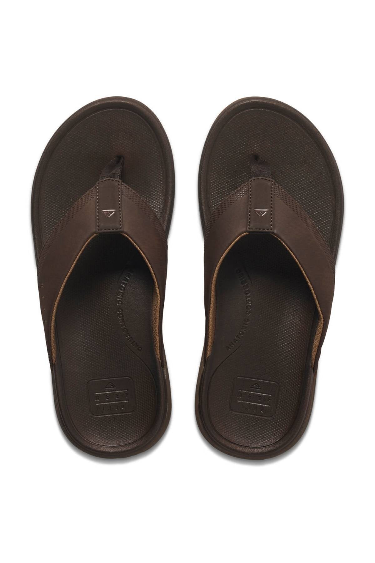 A pair of REEF Cushion Norte men's flip-flop sandals with wide brown straps and textured soles, featuring EVA foam cushioning, displayed side by side on a white background.