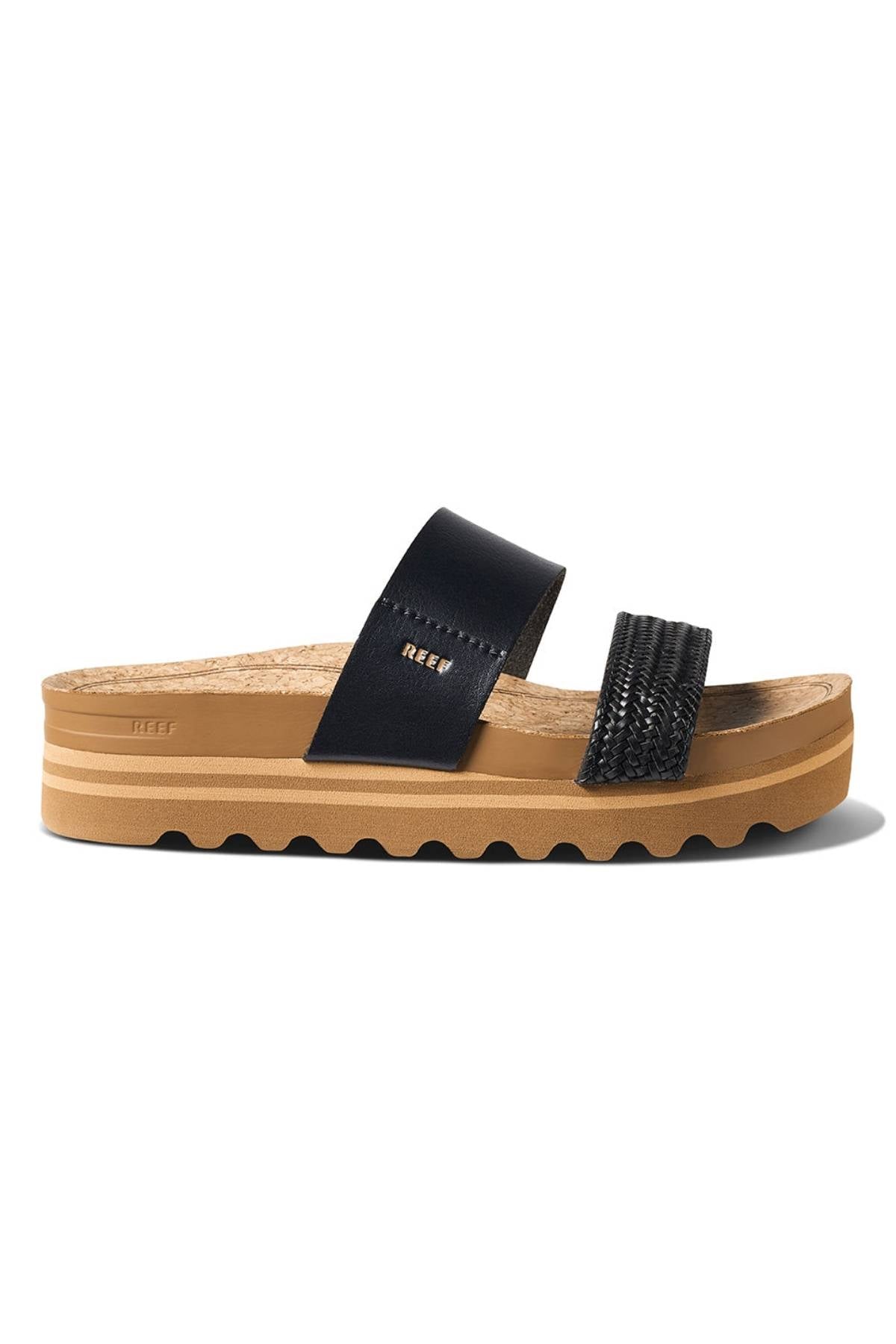 Side view of the REEF Cushion Vista Hi sandal featuring a tan platform sole, black upper straps (one smooth, one textured), cork footbed, arch support, and the "Reef" brand name on the side.