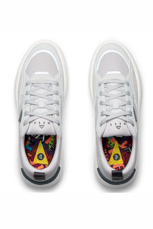 A top-down view of the Reef Fanning Mens Shoe in white with light gray accents and colorful patterned insoles, featuring abstract shapes and vibrant hues.