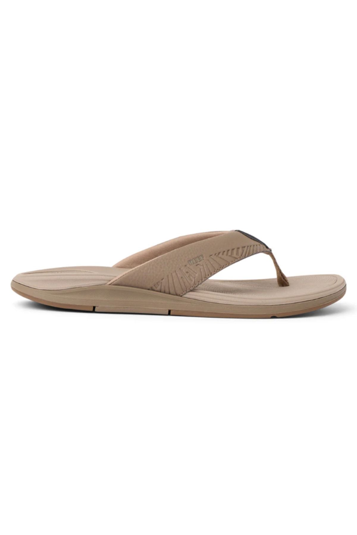 The REEF Offshore is a tan flip-flop sandal with a cushioned sole and wide fabric strap, shown in side profile on a white backgroundβideal for anyone seeking comfortable memory foam sandals from REEF shoes.