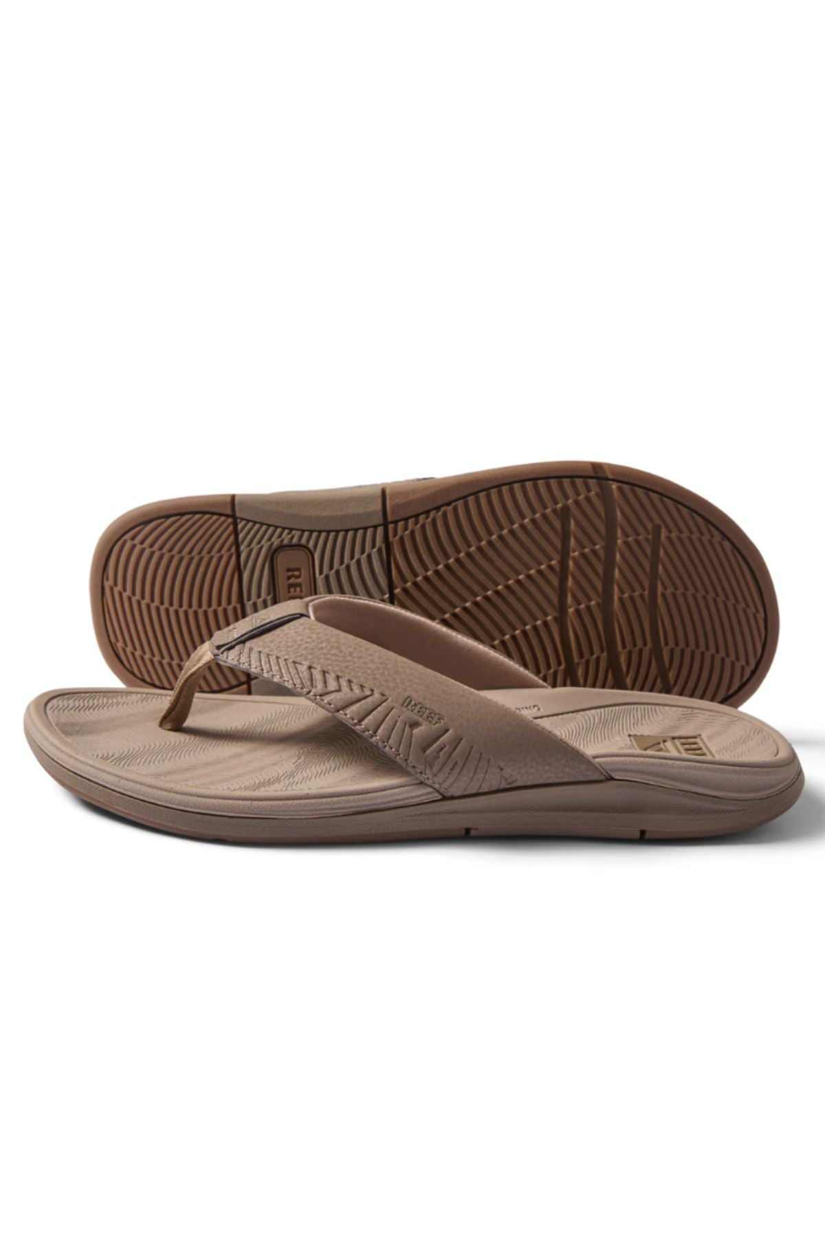 A pair of REEF Offshore brown flip-flop sandals, with textured soles and wide strapsβone flat, one propped to display the treadβoffer comfort similar to arch support sandals.
