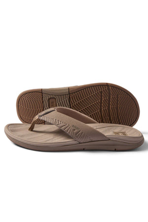 A pair of REEF Offshore brown flip-flop sandals, with textured soles and wide strapsβone flat, one propped to display the treadβoffer comfort similar to arch support sandals.