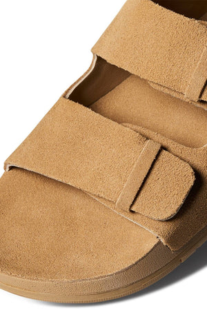 Close-up of the REEF Ojai Two Bar tan suede sandal with two wide Velcro straps, showcasing its soft texture and supportive sole. These sandals deliver comfort for everyday wear, photographed on a clean white background.