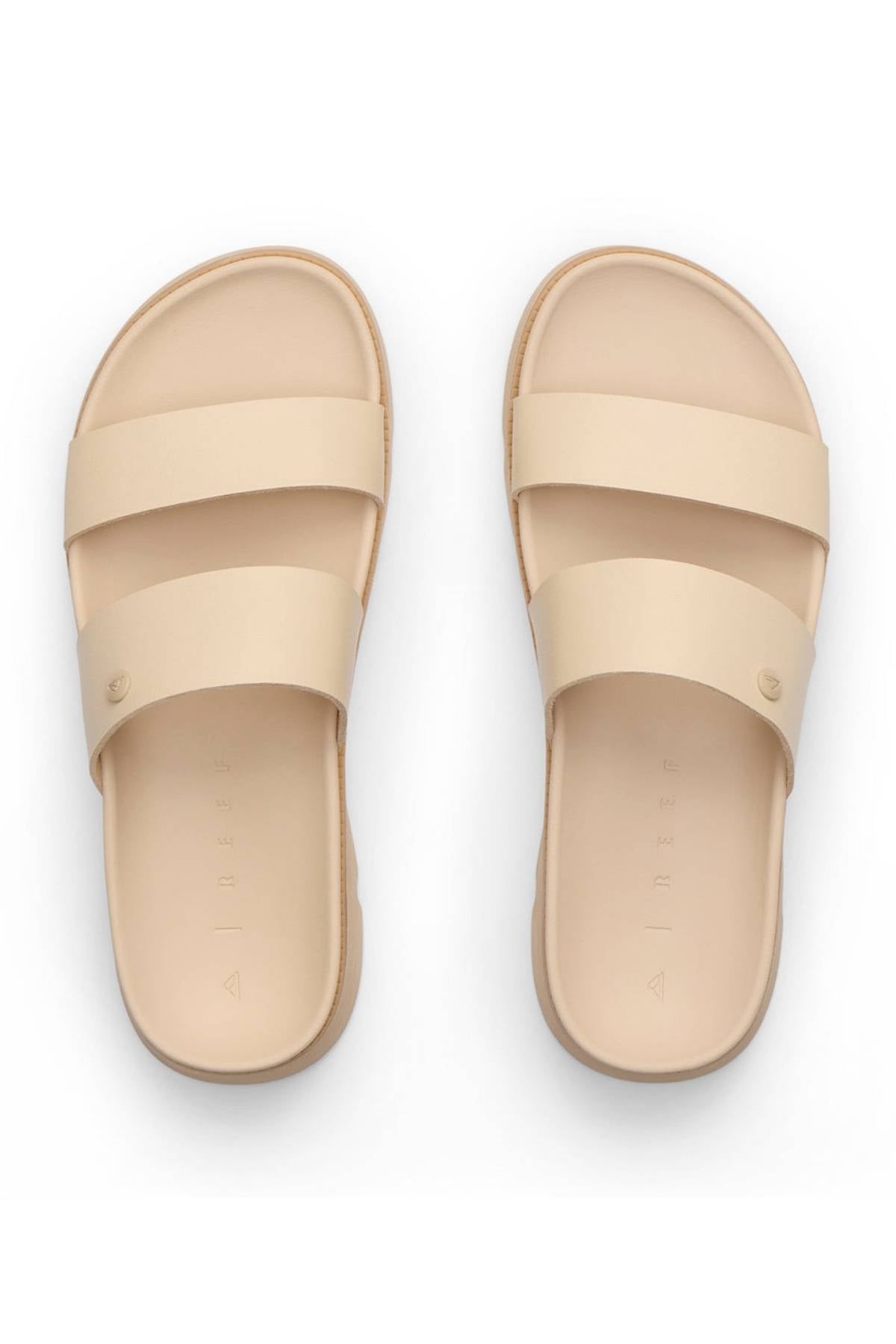 The REEF Vista Luxe Thea sandals in beige feature vegan leather, two wide straps, a minimalist modern design, and a comfortable footbed, shown from above on a white background.