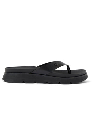 The REEF Vista Luxe Vivianahh is a black platform flip-flop sandal with a thick sole, cushioned footbed, wide single strap, and subtle grooved detailing—designed for all-day comfort and effortless style.