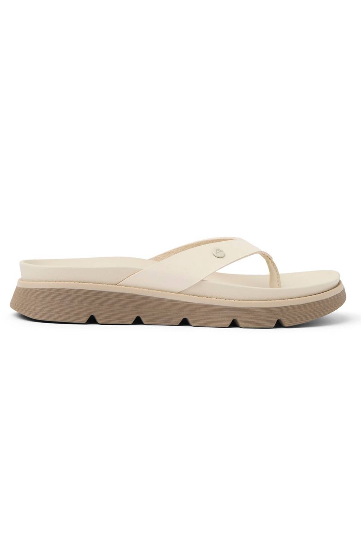 The REEF Vista Luxe Vivianahh is a beige flip-flop sandal featuring a thick ridged sole, cushioned footbed, and a simple wide strap, shown in side profile against a white background.