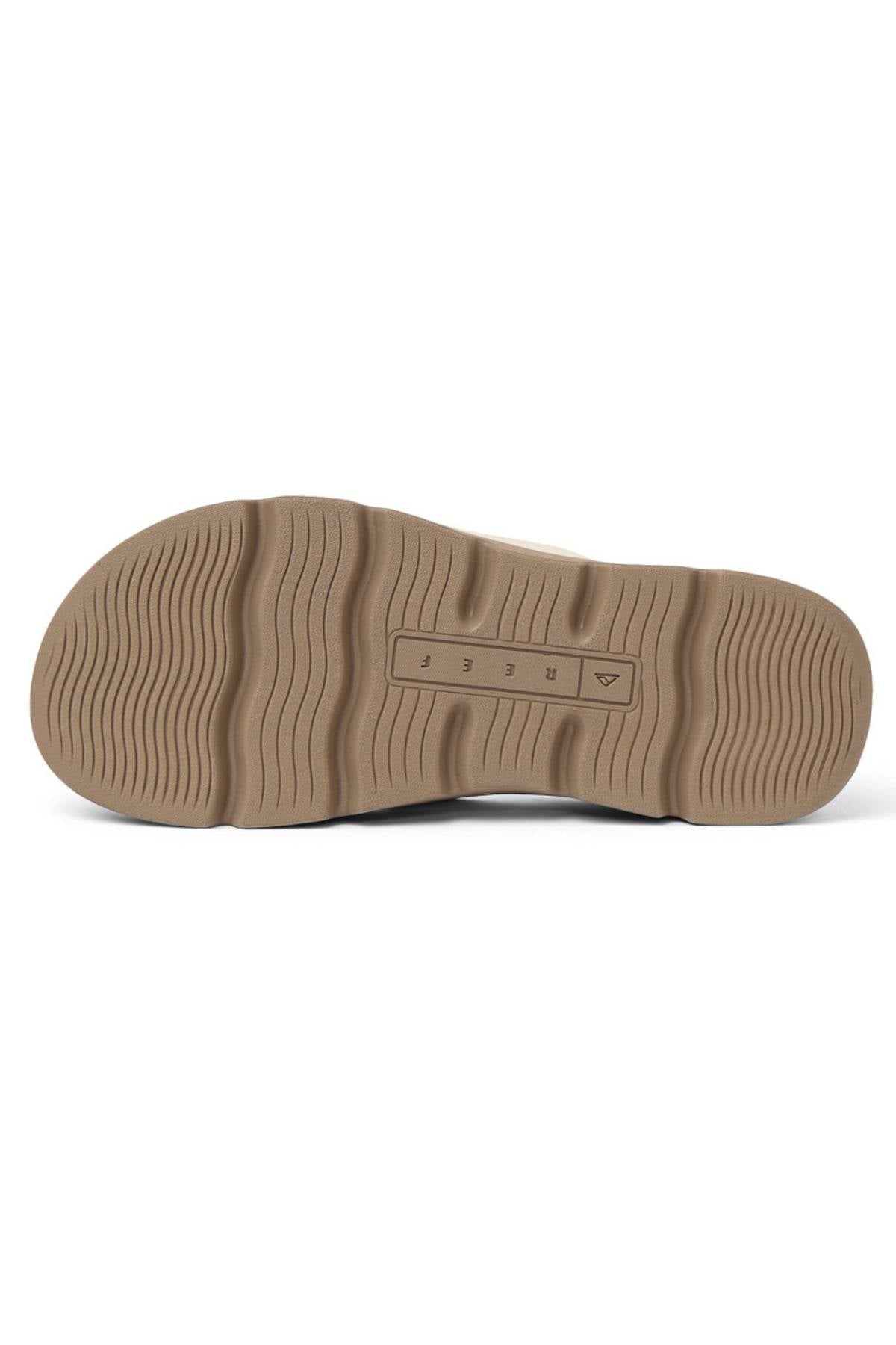 The image displays the bottom view of a beige REEF Vista Luxe Vivianahh sole, featuring wavy traction patterns and a small rectangular section with numbers and symbols in the center.