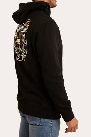 A man in the Ringers Western Eyrie Pullover Hoodie, featuring an embroidered eagle and "RANGERS" on the back, stands sideways in blue jeans, looking left. The brushed fleece fabric enhances his comfortable, casual style.