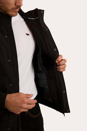 A man wearing a white t-shirt and the Ringers Western Kidman Jacket opens it to reveal its quilted lining and inner zip pocket. Only his torso and part of his face are visible.