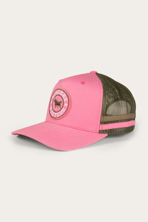 The Ringers Western McCoy Trucker Cap features a pink front panel and brim made from Cotton Twill, complemented by a green mesh back adorned with two pink and tan stripes. The front showcases a circular emblem with the text "Ringers Western" alongside a bull image.