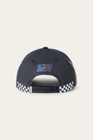 A rear view of the Ringers Western Ringers Racing Baseball Cap in black, showcasing a blue and orange embroidered number “12” above the adjustable strap and a black-and-white checkered pattern running along the bottom edge.