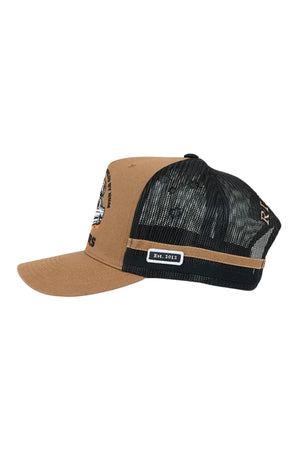 The Ringers Western Rum Runner Trucker Cap has a brown and black design with a mesh back, flat brim, and an "Est. 2012" patch. Embroidered Rum Runner text and graphics decorate the front for standout style.