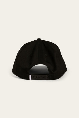 A rear view of the Ringers Western Rye Baseball Cap showcases its sleek black cotton twill design, complemented by an adjustable strap with a snapback closure. A small white rectangular tag can be seen on the left side of the strap, all set against a plain light-colored background.