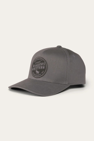 The Ringers Western Rye Baseball Cap is a gray cap crafted from cotton twill. It features a curved brim, eyelets for ventilation, and a black circular patch on the front displaying the words "Ringers Western.