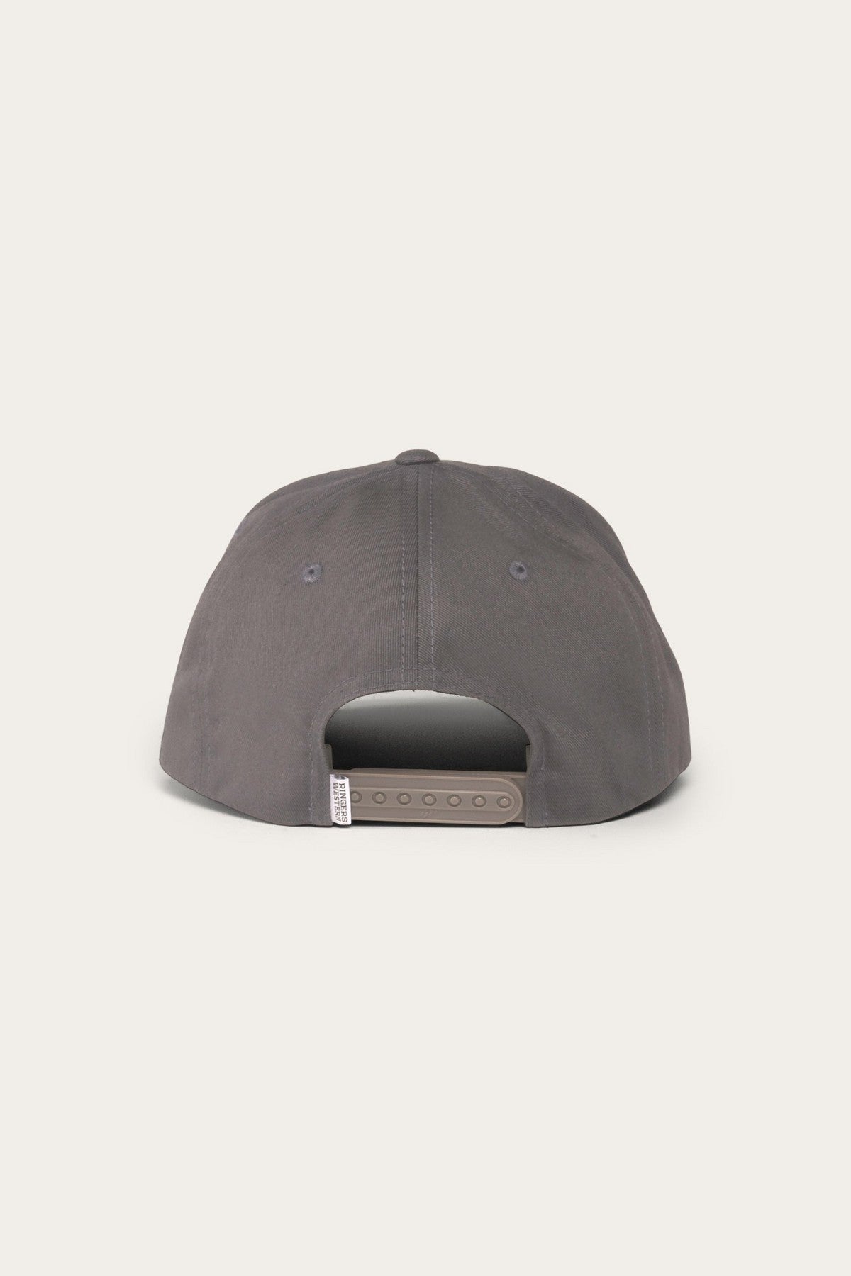 The image shows the back view of a dark grey Ringers Western Rye Baseball Cap made from Cotton Twill. The cap features a snapback closure with multiple adjustment holes. The plain, light-colored background provides a nice contrast to the hat.