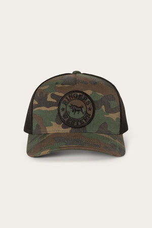 The Ringers Western Signature Bull Trucker Cap is a camouflage cotton twill baseball cap with a black mesh back and a round patch on the front that reads “Ringers Western” alongside an image of a bull. This classic trucker cap features a snapback closure for adjustable comfort.