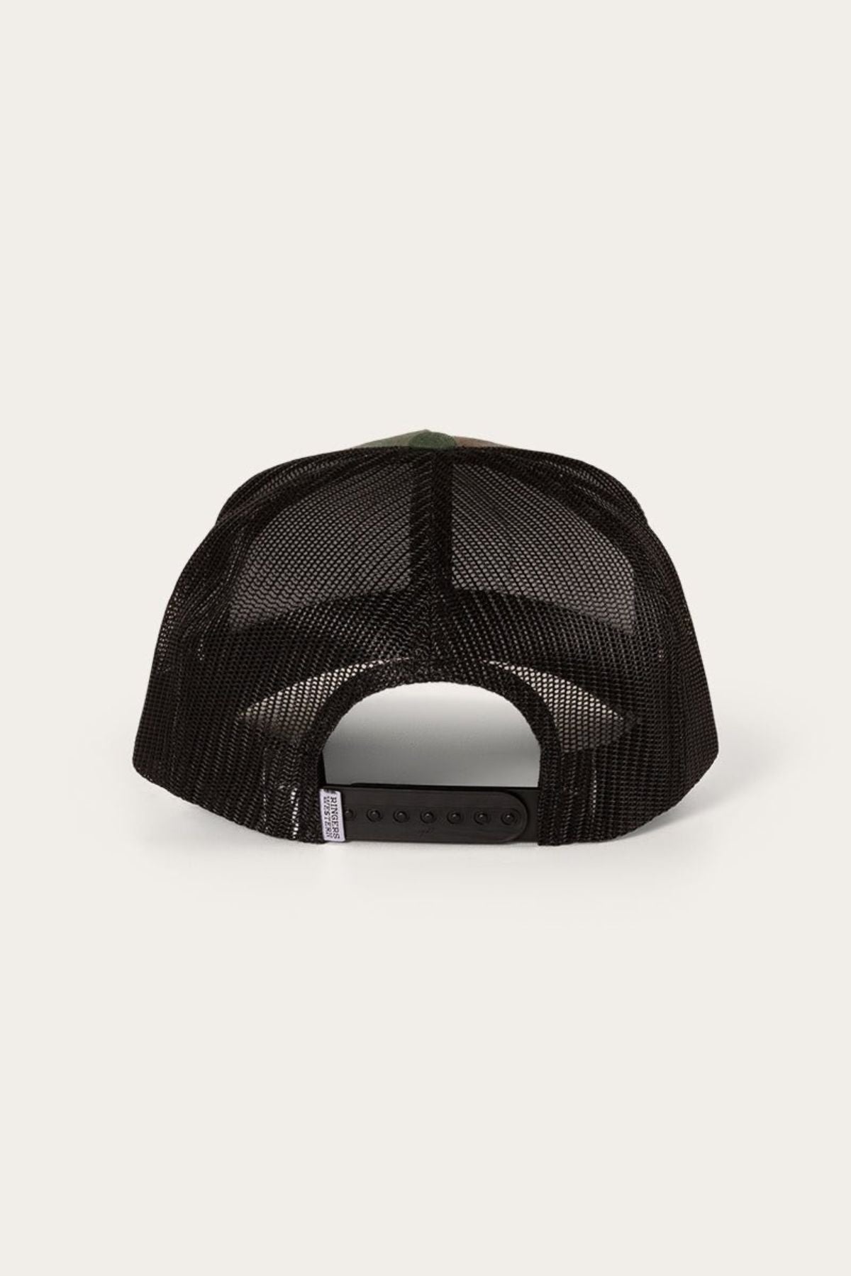 The image shows the back view of a black mesh Ringers Western Signature Bull Trucker Cap with an adjustable snapback closure, displayed against a light beige background.