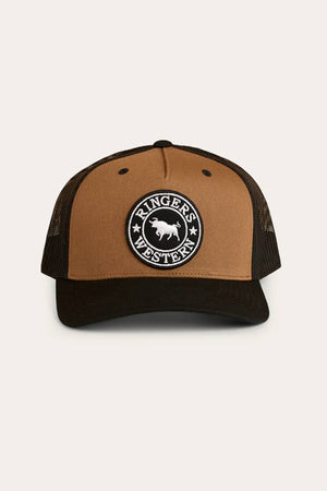 The Ringers Western Signature Bull Trucker Cap is brown and black with a circular white bull patch on the front. It features a mesh back, curved brim, and adjustable strap for a comfortable fit.