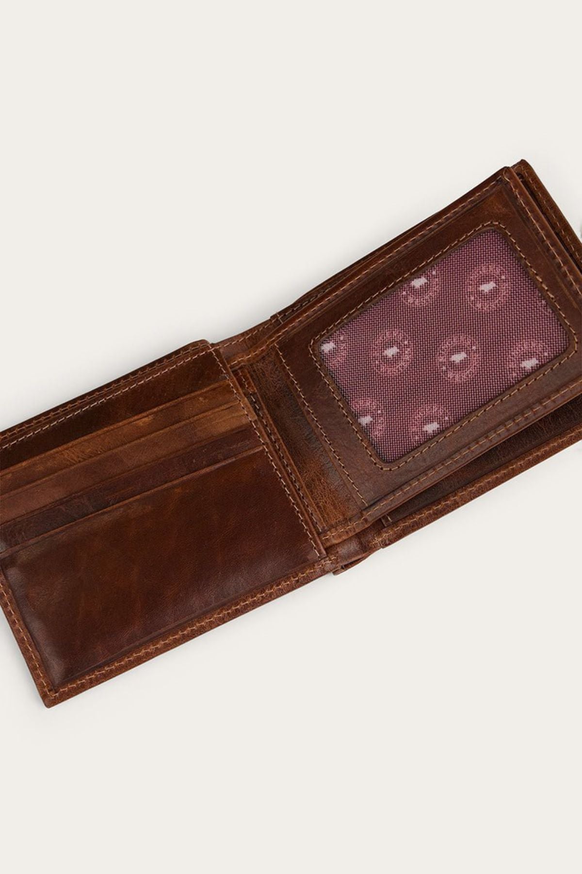 The Ringers Western Toro Biggo Wallet is open, displaying card slots on the left and a transparent ID window with a patterned red background on the right.