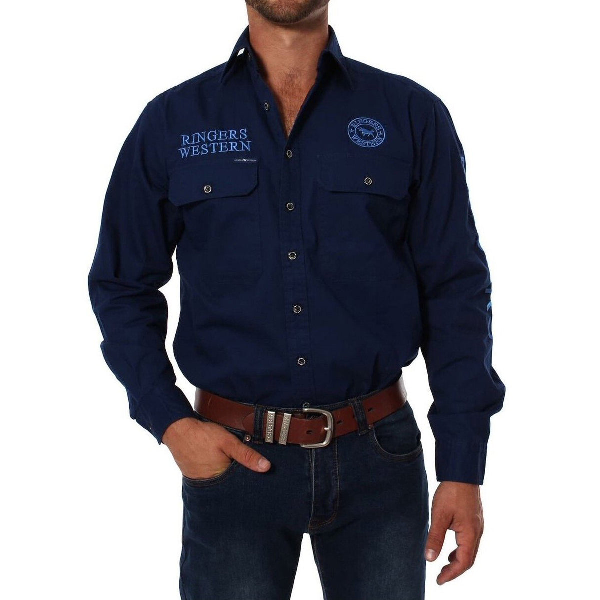 A person wearing a Ringers Western Hawkeye Embroidered Shirt in dark blue with UPF50+ protection, "Ringers Western" on the right chest, and a circular logo on the left. They have one hand in their dark blue jean pocket and sport a brown leather belt.