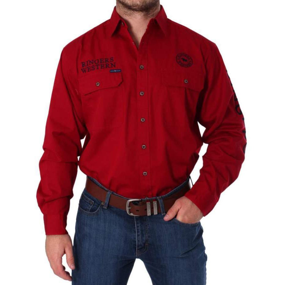 Someone is dressed in the Ringers Western Hawkeye Embroidered Shirt, a red long-sleeve made of 100% cotton with patches on the chest and arm, paired with blue jeans and a brown leather belt.