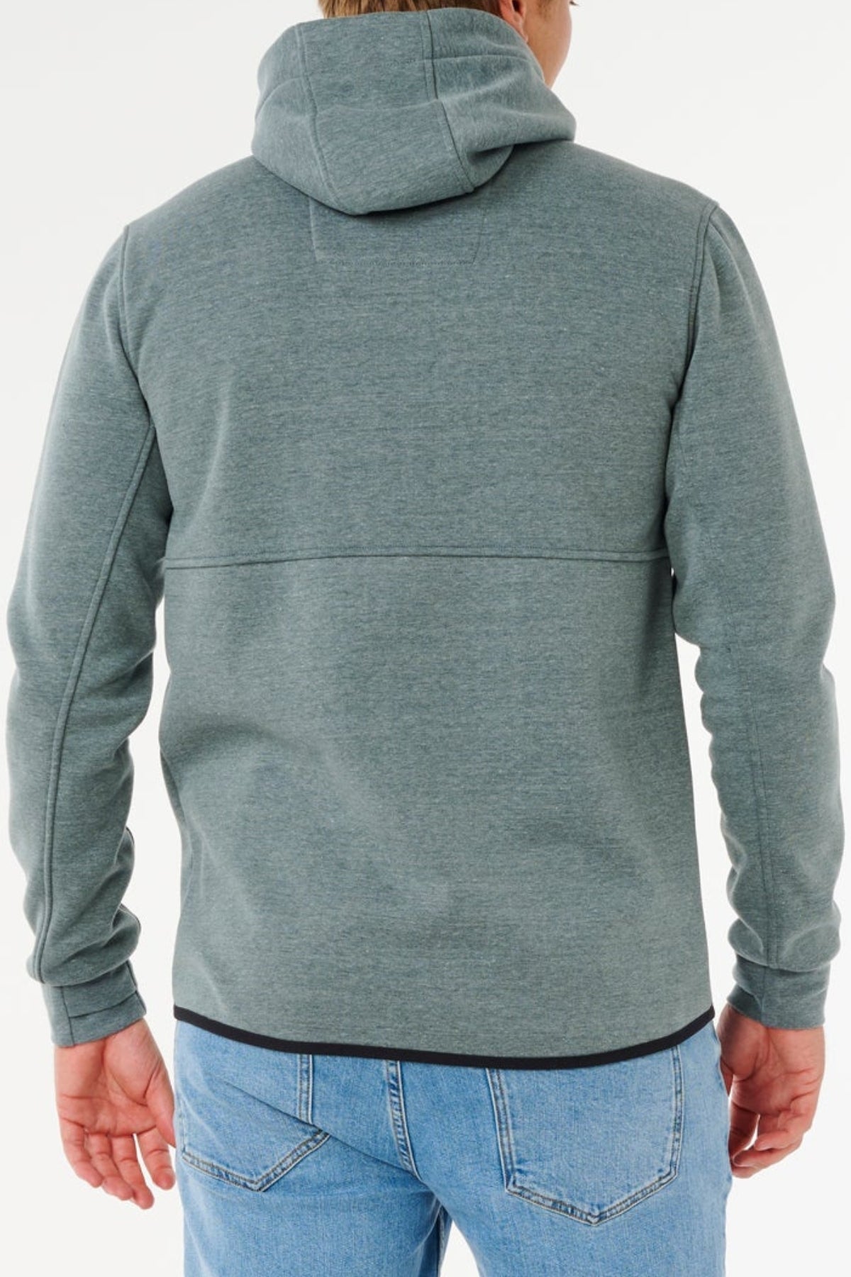 A person wears a Rip Curl Anti Series Departed Zip Thru, a water-resistant winter hoodie, paired with light blue jeans and shown from the back against a plain white background.
